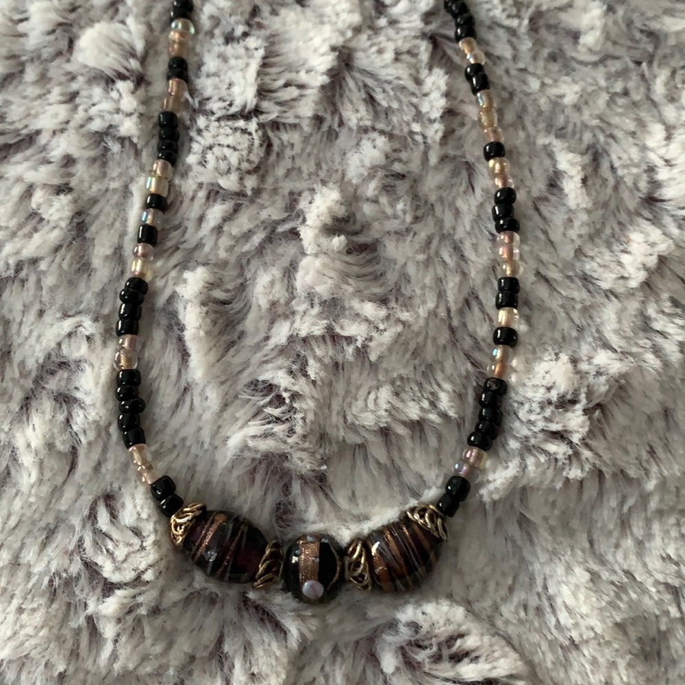 5/$25 longer beaded necklace in blacks, browns, creams, and gold. Toggle clasp.